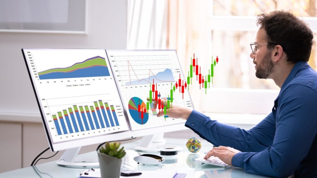 Sales & Demand Forecasting Services An image of a man point to dashboard on the monitor screen