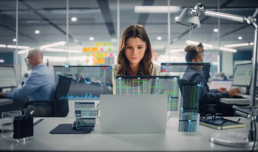Data Scientist to Consultant: The Truth About Switching Data consultant analyzing financial data on multiple transparent screens in a modern office environment.